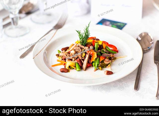 delicious meat salad with meat on white plate