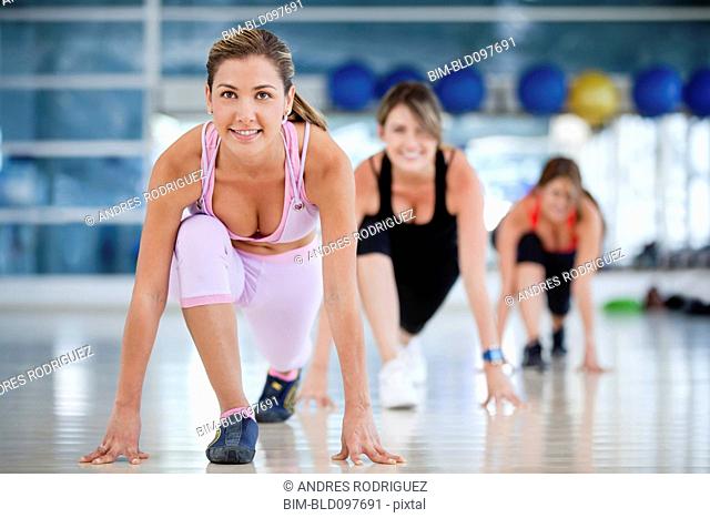 Hispanic women exercising in health club
