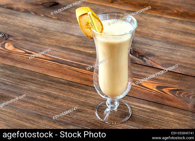 Glass of Dirty Banana Cocktail on wooden background.