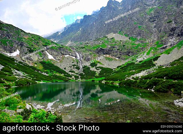 Landscape in the High Tatras with mountains, lake Velicke pleso and the waterfall Velicky vodopad. Slovakia