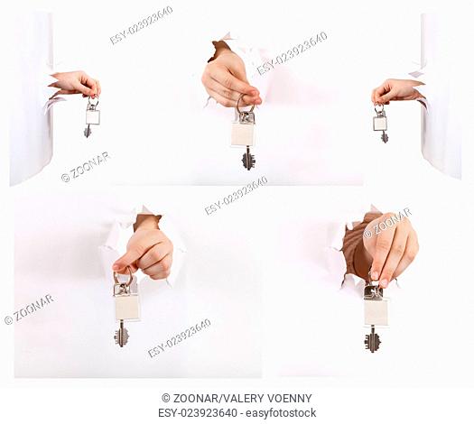 set of hands holding the keychain through a hole