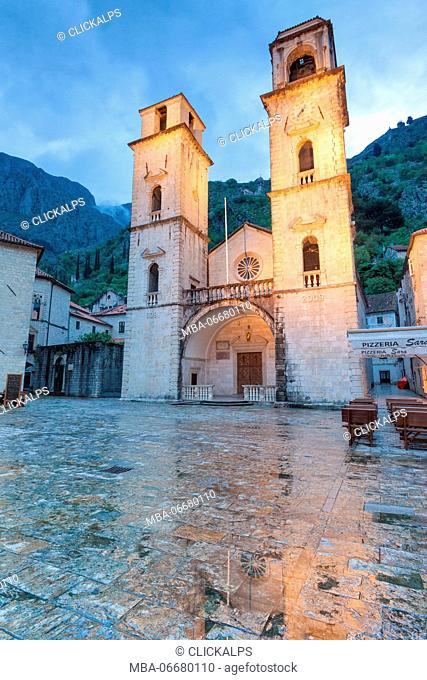 The square in front of the church and the beautiful exterior facade of the Cathedral of St. Tryphon at dusk. Kotor, Montenegro