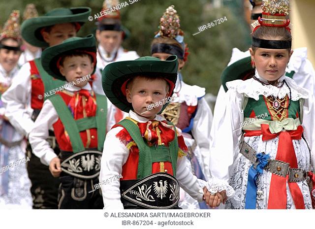 Children wearing traditional costumes of the Val Gardena Valley during a traditional procession in the village of Santa Cristina in the Val Gardena Valley