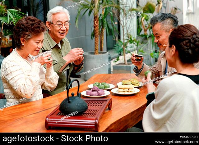 The elderly chat over a cup of tea