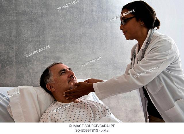 Female doctor checking male patient