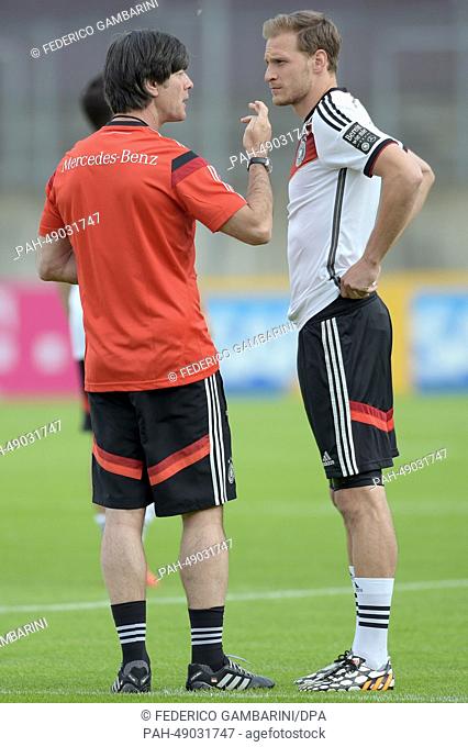 Germany's head coach Joachim Loew (L) talks with Benedikt Hoewedes during a practice session in Duesseldorf,  Germany, 31 May 2014