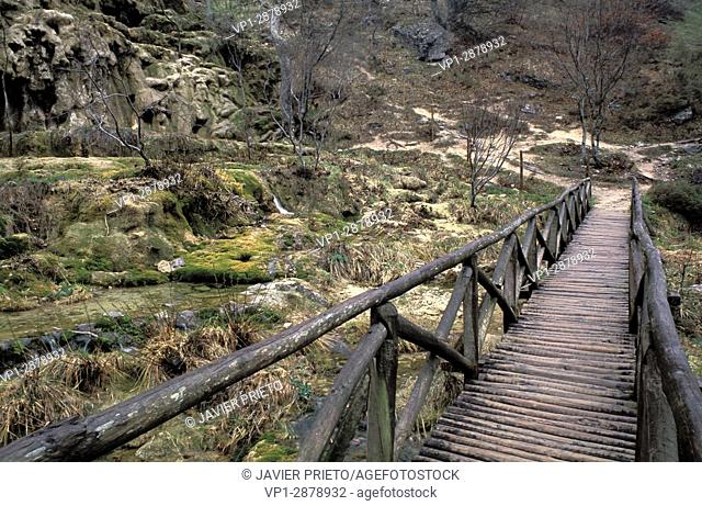 Wooden bridge. Birth of the Ibias River. Valley of Covalagua. The Las Loras World Geopark. Covalagua Natural Space. Palencia. Castilla y León. Spain
