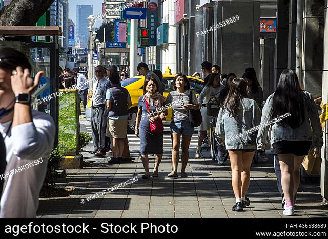 Passersby walk in downtown Taipei, Taiwan on 28/11/2023 Recent survey findings reveal an increasing majority of Taiwanese favour permanently maintaining the...