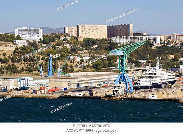 Blue and green gantry cranes and shipping containers on the docks in commercial port, Marseilles, Provence, France, Europe