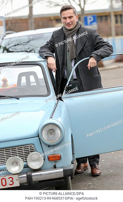 13 February 2019, Saxony, Zwickau: Martin Dulig, Minister of Economics of Saxony (SPD), stands in front of the Horch Museum next to a Trabant car after driving...