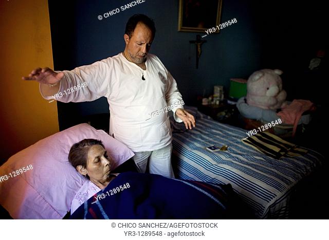 Reiki Master Ramon Quiroz gives Reconnective Healing to a patient dying of cancer in her home in Mexico City, September 30