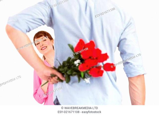 Man holding roses behind him