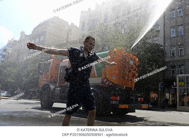 A tank truck of the ""Technical Road Administration Prague"" (TSK) sprinkles by water the Wenceslas Square in Prague, Czech Republic, on June 5, 2019