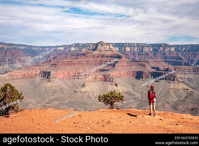 A female hiker enjoying the view from the famous Grand Canyon from South Kaibab trail, USA