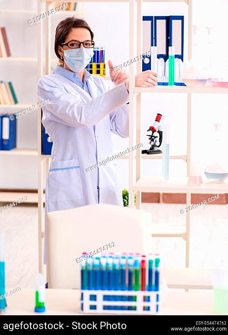 The female chemist working in hospital lab