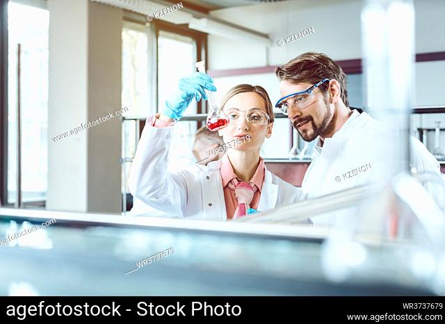 Two happy chemical scientists during breakthrough experiment