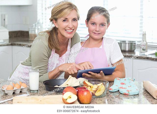 Happy mother and daughter preparing cake together