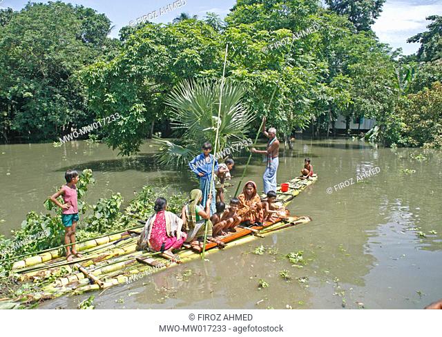 Flood affected people using banana raft to go from one place to another, at the village of Sibaloy, in Manikganj, Bangladesh August 2, 2007