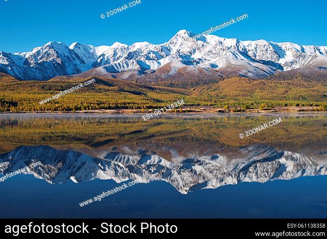 View on Altai lake Dzhangyskol on mountain plateau Eshtykel. North Chui ridge is reflecting in the water. Altai, Siberia, Russia
