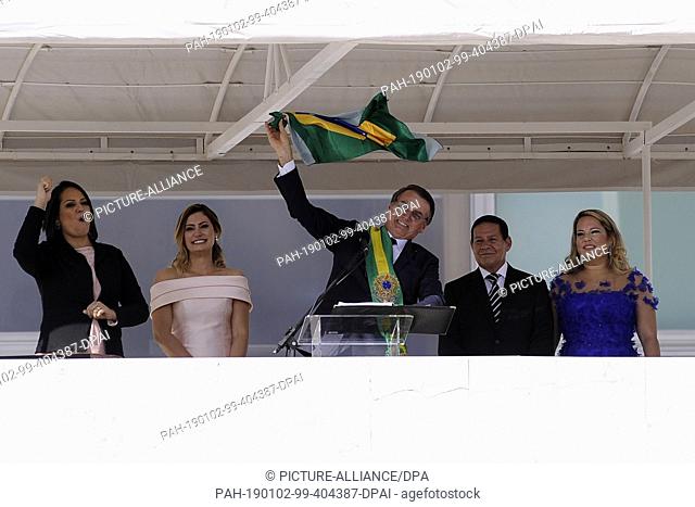 01 January 2019, Brazil, Brasilia: Brazil's new president Jair Bolsonaro (M) waves to the crowd from the Planalto presidential palace
