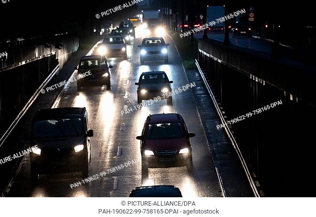 22 June 2019, Bavaria, Munich: Cars drive in the rain over the Mittlerer Ring. A thunderstorm with heavy rain has hit Munich on Saturday evening