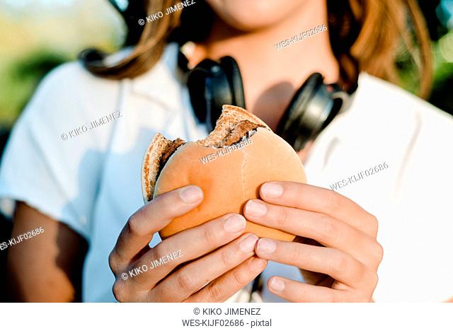 Close-up of woman's hands with hamburger