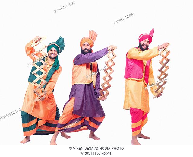 Dancers playing musical instrument performing folk dance bhangra MR779F, 779B, 779C