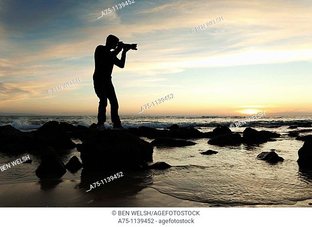Silhouette of photographer on the beach