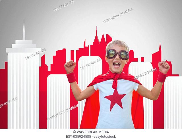 Boy against grey background with superhero costume and skyscraper city skyline