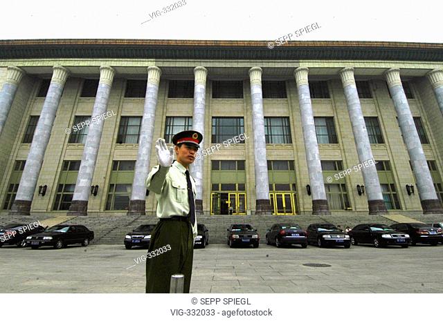 Peking, capital of the People's Republic of China. Chinese policeman on the backside of The Great Hall of the People, site of the Chinese National Assembly