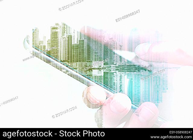 holding mobile phone / smartphone with city skyline double exposure