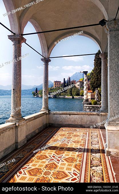 The veranda of an old villa has fabulous views of Lake Como and surrounding villages. From Wiki: Lake Como is a lake of glacial origin in Lombardy, Italy
