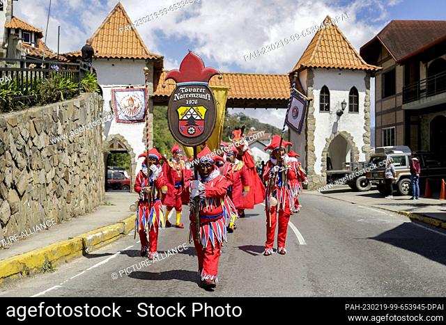 18 February 2023, Venezuela, La Colonia Tovar: People dressed as Jokili take part in a parade during a carnival celebration