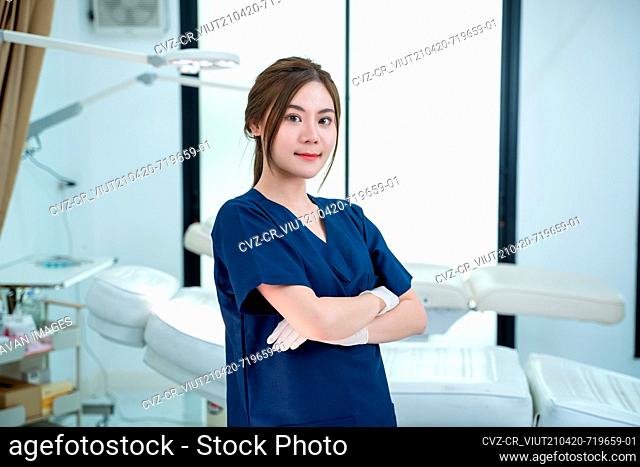 Portrait of beautiful female doctor standing in beauty salon pla