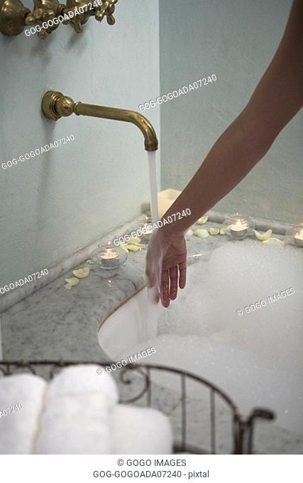 Woman testing bathwater
