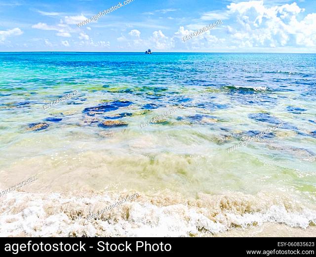 Tropical mexican beach panorama view with turquoise blue clear water cenote and boulder stones and rocks from Playa 88 and Punta Esmeralda in Playa del Carmen...