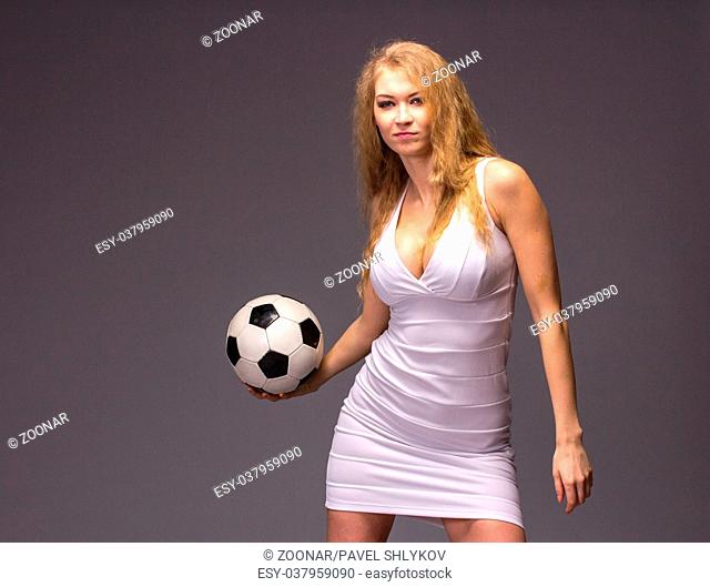 Young Woman In White Evening Dress with soccer ball
