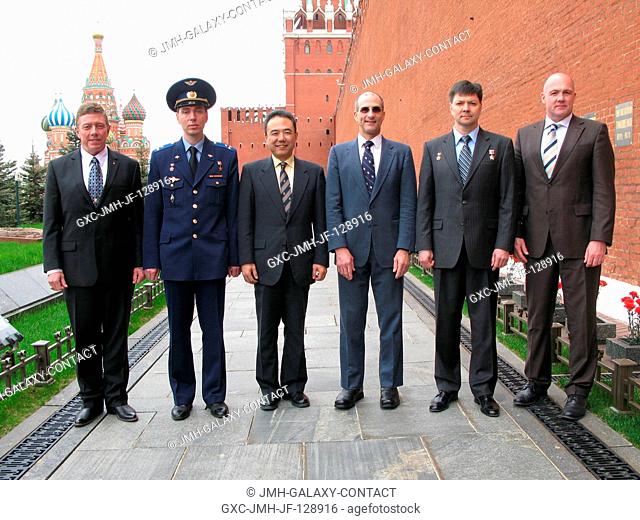 The prime and backup crew members for Expedition 28 to the International Space Station pose for pictures at the Kremlin Wall in Red Square May 16