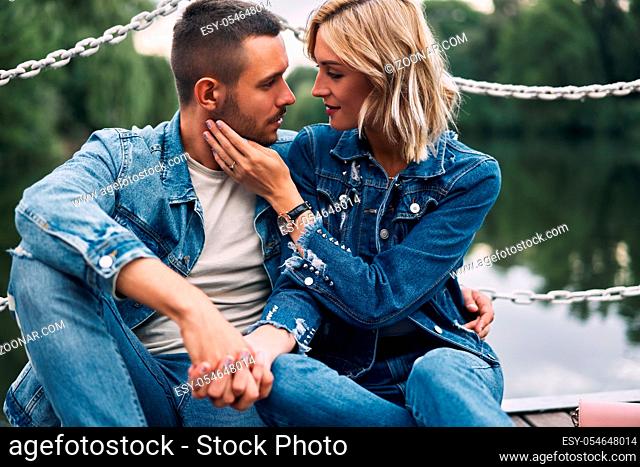 Romantic young couple relax on nature. Love, hugs, happy relationship concept