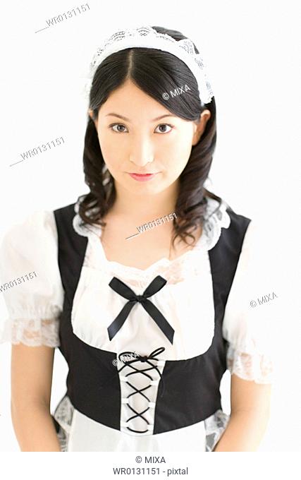 A young woman in French maid outfit smiling