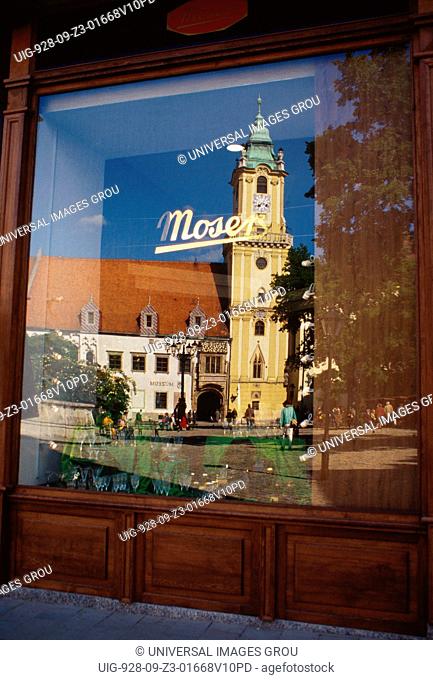 Slovakia, Bratislava. Old Town Hall Reflected In Shop Window, Hlavne Square
