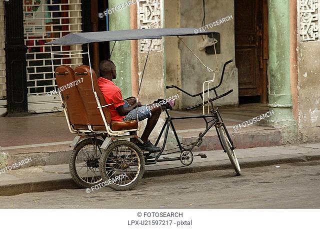 A man sitting in a Pedicab