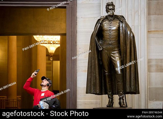 A tourist stands near a statue of former US President Andrew Jackson in the US Capitol Rotunda. Private citizen Jackson had ninety-five enslaved individuals who...