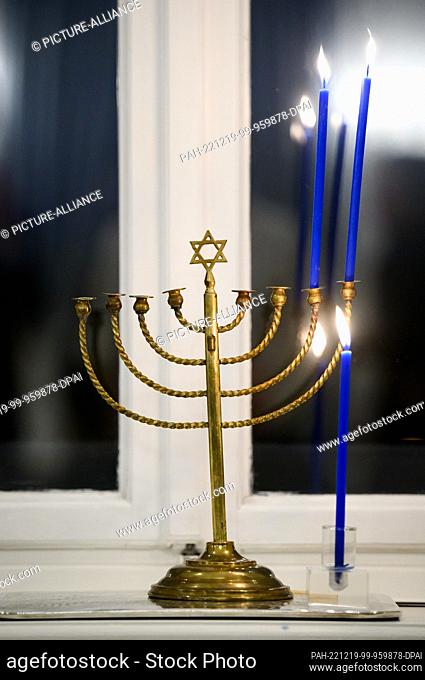19 December 2022, Berlin: The Posner family's Hanukkah candelabra stands in a window of Bellevue Palace during a joint Hanukkah celebration by German President...