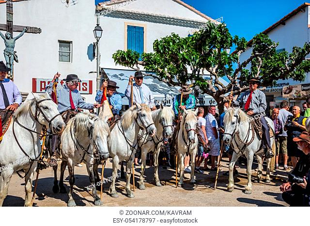 Sent-Mari-de-la-Mer, Provence, France - May 25, 2015. World Festival of Gypsies. Convoy - guards on white horses before the start of the parade