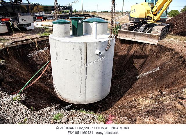 Environmentally friendly septic tank being lowered into ground