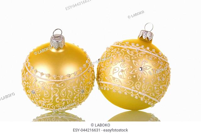 Two beige Christmas ball ornaments and crystals, isolated on white background