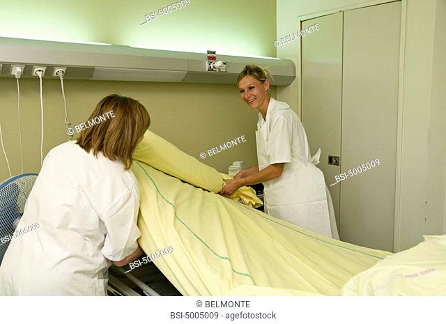 Photo essay at Saint-Louis hospital, Paris, France. Nurses's aides in the department of endocrinology. Change of bed sheets