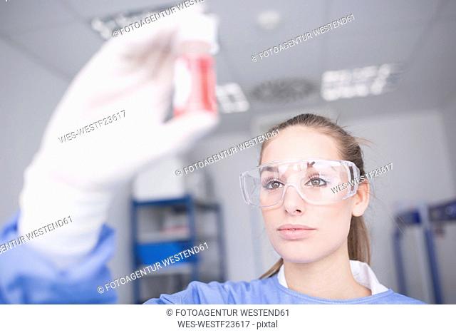 Scientist in lab examining sample