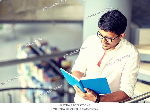 hindu student boy or man reading book at library